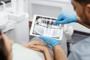 An Alvarado dentist showing a patient their dental x-rays