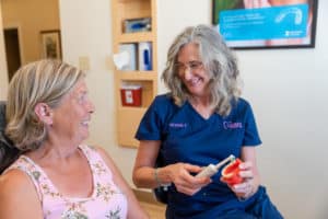 dental hygienist talking to her patient about dental cleaning and dental examinations