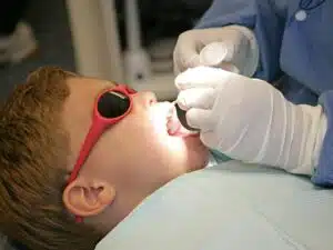 A young patient getting a fluoride treatment in Alvarado, TX