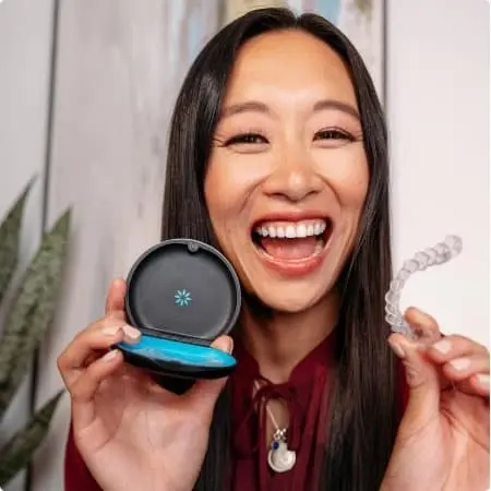 photo text media woman smiling holding aligners and case